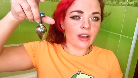 Ebony girl with big tits spreads her ass lips with a dildo