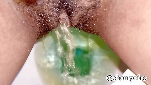 Ebony beauty pissing up close in front of the camera