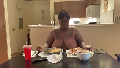 Sexy ebony woman in lingerie enjoys smoking a pipe