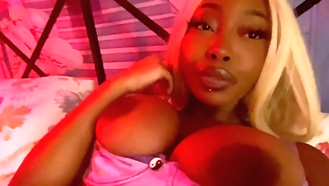 Ebony babe with big tits masturbates herself on a couch
