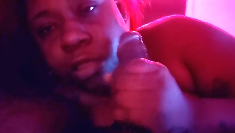 Ebony milf in red dress giving handjob to big cock