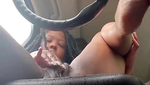 Black chick with a tattooed pussy sucks her fingers