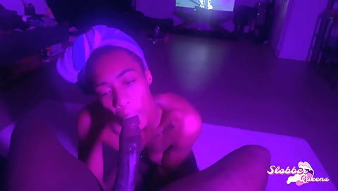 Tattooed ebony beauty gives a blowjob to a black guy